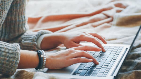 Remote job. Freelance technical content writer. Woman working from home. Closeup of female hands typing on laptop.